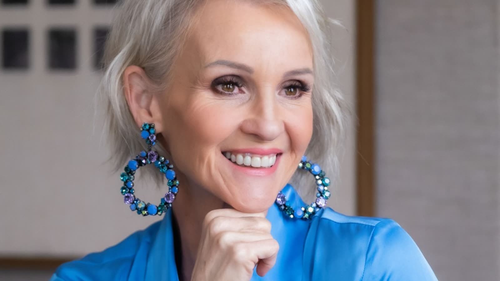 Linda Paige close-up in navy silk with statement earrings — Executive Coach and Stylist
