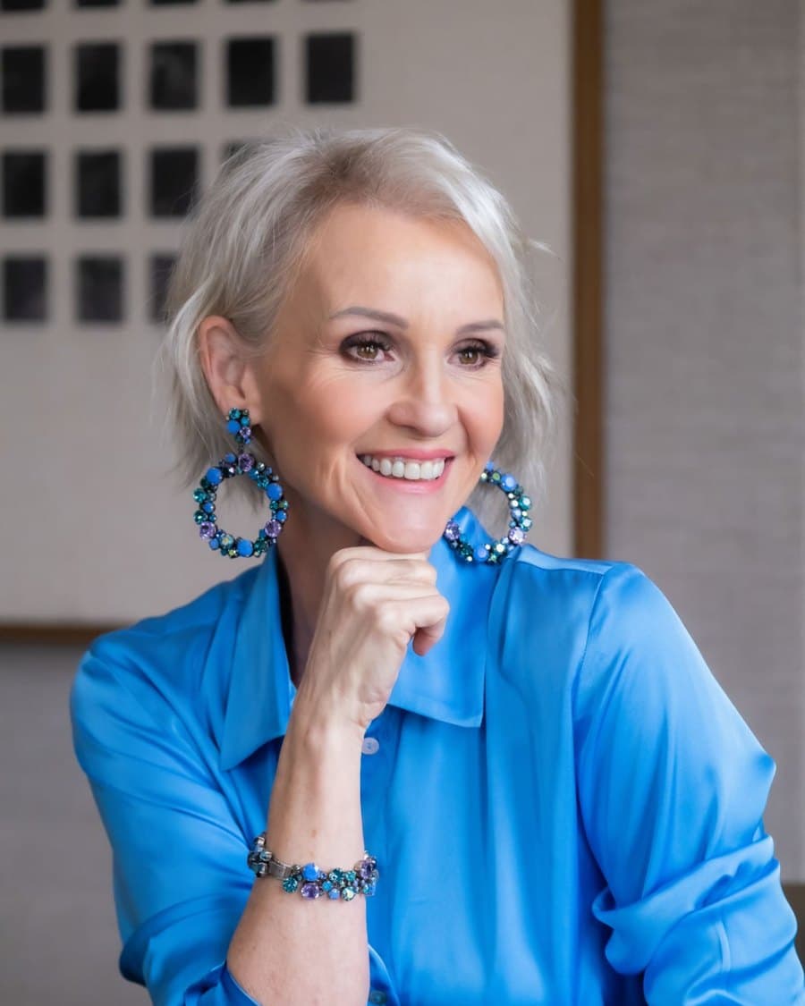 Linda Paige close-up in navy silk with statement earrings — Executive Coach and Stylist